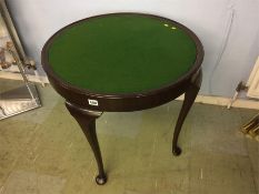 A pad foot circular table, with green baize