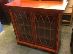 A yew wood glazed cabinet