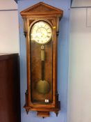 A walnut single weight wall clock