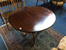 A 19th century mahogany circular tilt top tripod table