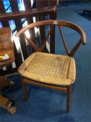 A pair of Henning Kjaernulf for Bruno Hansen Danish teak chairs with wishbone carved backs and woven