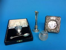 A silver watch case cover, egg cup and a bud vase