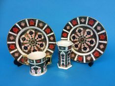 A Royal Crown Derby loving cup, two plates and an octagonal vase (4)