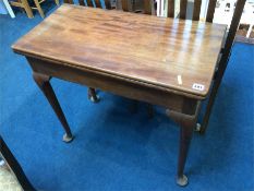 A Georgian mahogany fold over tea table with pad feet