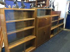 A collection of four sliding door bookcases