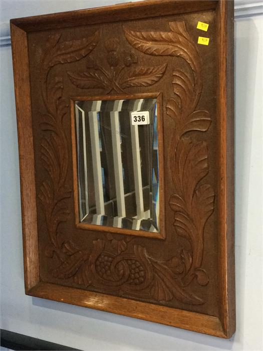 A carved oak framed mirror