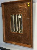 A carved oak framed mirror