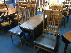 An oak gateleg table and four chairs
