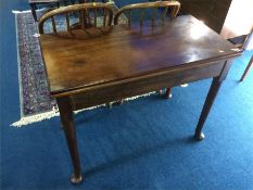 A 19th century mahogany fold over tea table, ending in pad feet