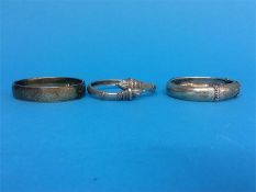 A silver engraved bangle by Charles Horner and two other bangles (3)