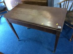 A 19th century mahogany fold over tea table