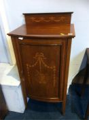 An Edwardian mahogany bow front music cabinet