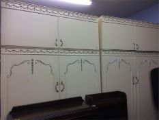 A pair of cream double door wardrobes (each with a top box)