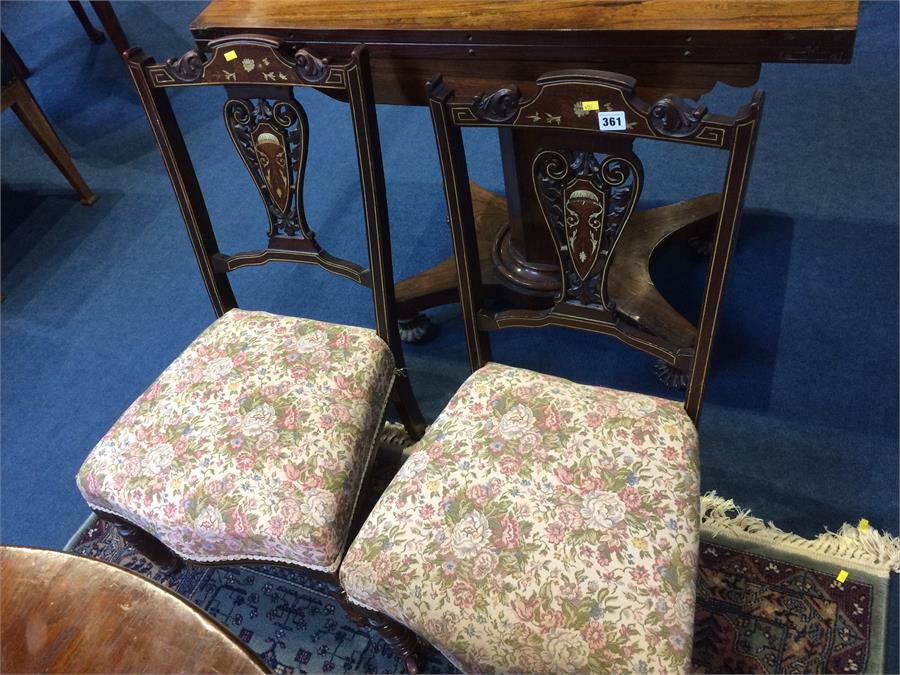 A pair of Edwardian marquetry inlaid nursing chairs