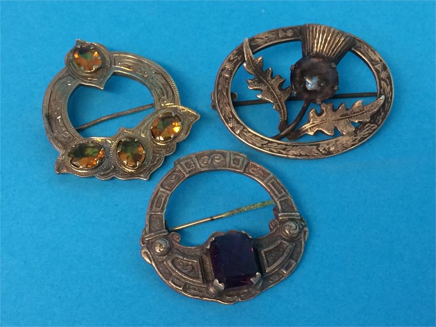 A silver Scottish brooch, a sterling silver Scottish brooch and another Scottish design brooch (3)