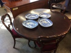 A mahogany circular breakfast table and three Victorian single chairs