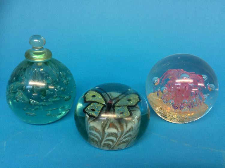 A Victorian glass inkwell and two paperweights