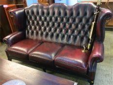 An Oxblood Chesterfield high back three seater settee