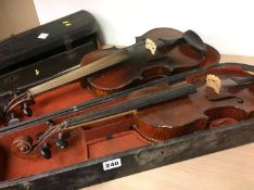 Two violins in coffin cases