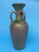 An Antique style speckled green glass three handled vase