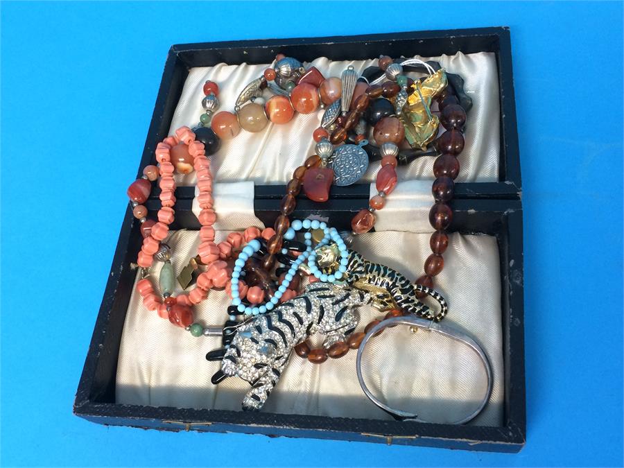 A box of necklaces, brooches etc.