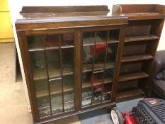 An oak china cabinet and a small open bookcase