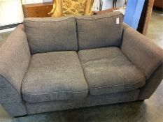 A brown two seater settee