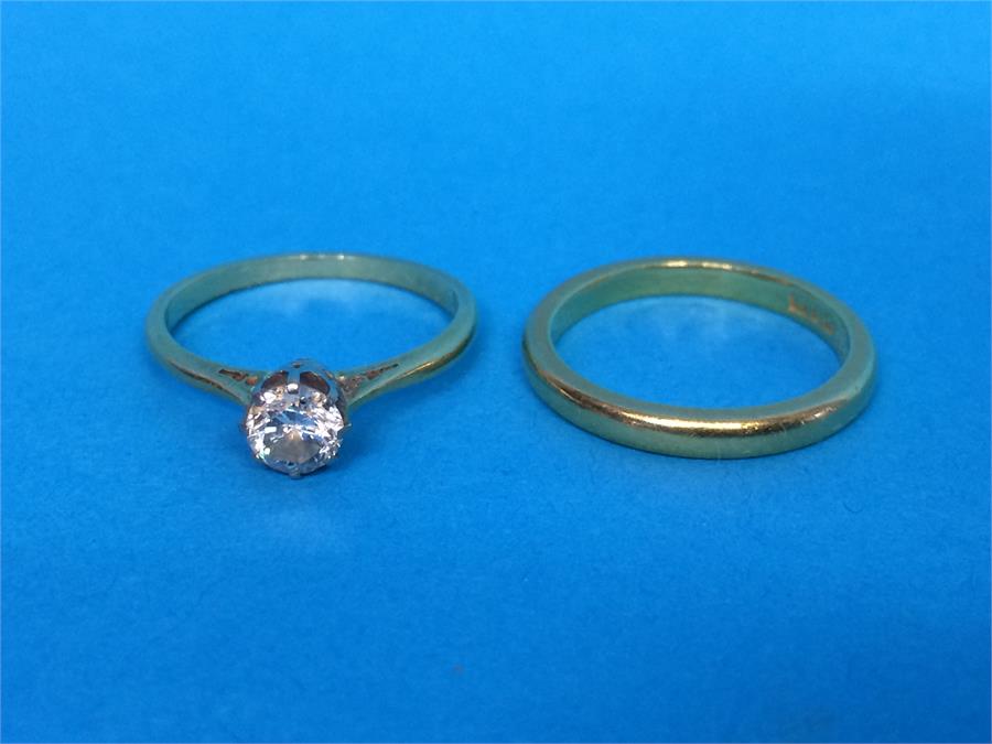 A diamond mounted yellow metal ring and one other