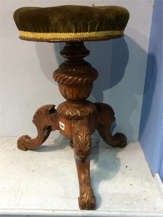 A Victorian circular top carved piano stool