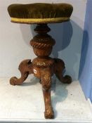 A Victorian circular top carved piano stool