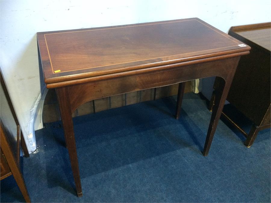 A 19th century mahogany rectangular top fold over card table