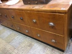 A long haberdashery chest of drawers, having 8 long deep drawers, 245cm length, 42cm deep, 77cm