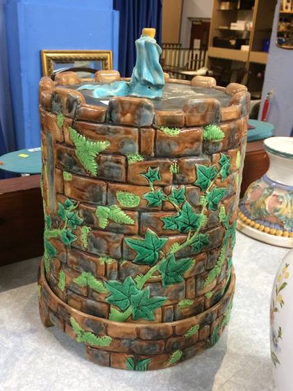 A George Jones Majolica castellated turret cheese dish and cover, numbered 3341, 33cm high