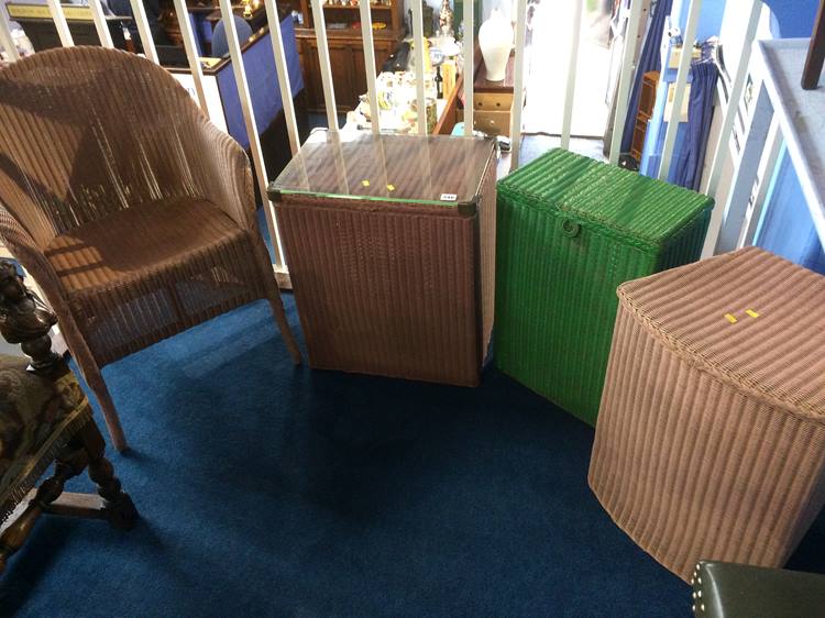 A Lloyd Loom chair and three Lloyd Loom linen boxes