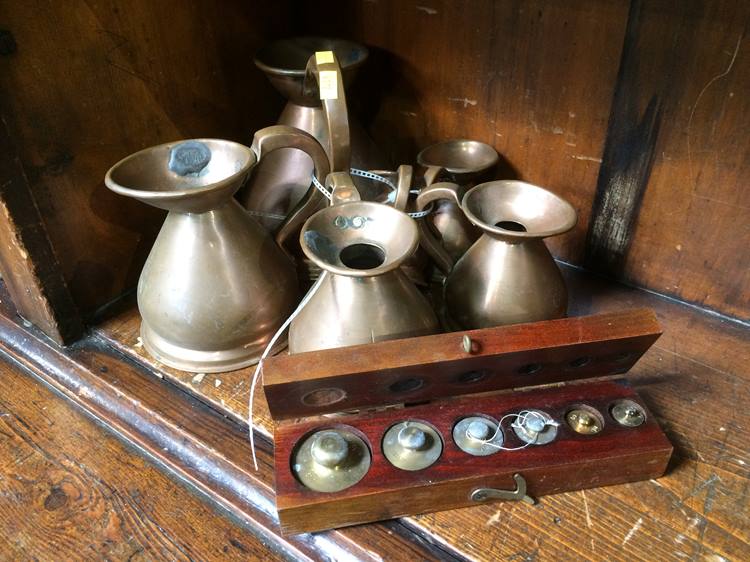 A set of 6 graduated copper measures and boxed brass weights