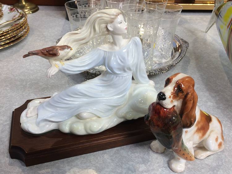 A Royal Doulton dog with a pheasant in his mouth and a Coalport figurine
