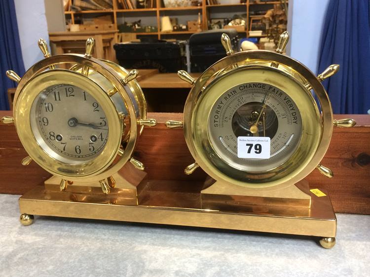 A brass Chelsea Ships Bell Clock and Barometer, both in the form of a Ships wheel. The clock and