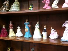 Eight various Doulton, Worcester and Coalport figures