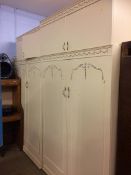 Two cream double door wardrobes and two removable top boxes