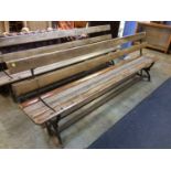 A cast iron and slatted wood tram bench with reversible seat, 255cm length