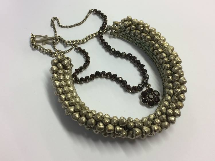 An Indian silver coloured garnet necklace and an Indian necklace