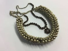 An Indian silver coloured garnet necklace and an Indian necklace