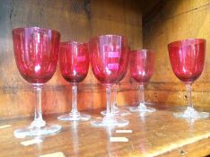 Six cranberry coloured glasses