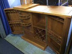 A carved Oriental bar with folding top, the double door open to reveal a fitted interior