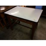 A white enamelled table top with pine base, 92cm wide