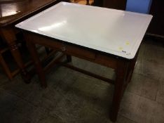 A white enamelled table top with pine base, 92cm wide