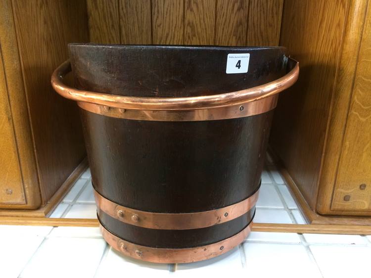 A mahogany peat bucket, with copper handle and three copper bands, 30 cm high