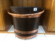 A mahogany peat bucket, with copper handle and three copper bands, 30 cm high