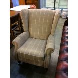 A Parker Knoll reclining armchair of beige tartan pattern