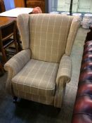 A Parker Knoll reclining armchair of beige tartan pattern